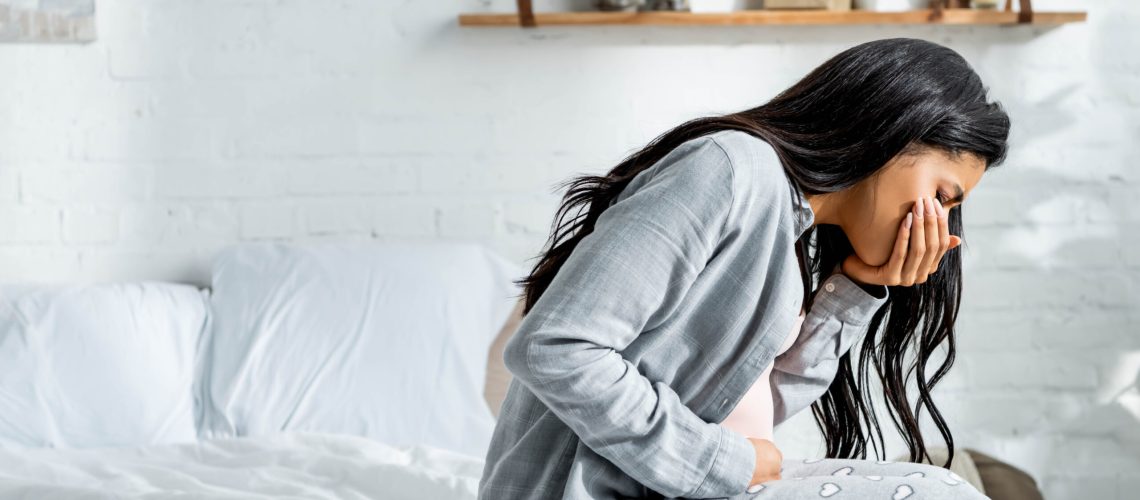 pregnant african american woman having toxicosis vomit in apartment