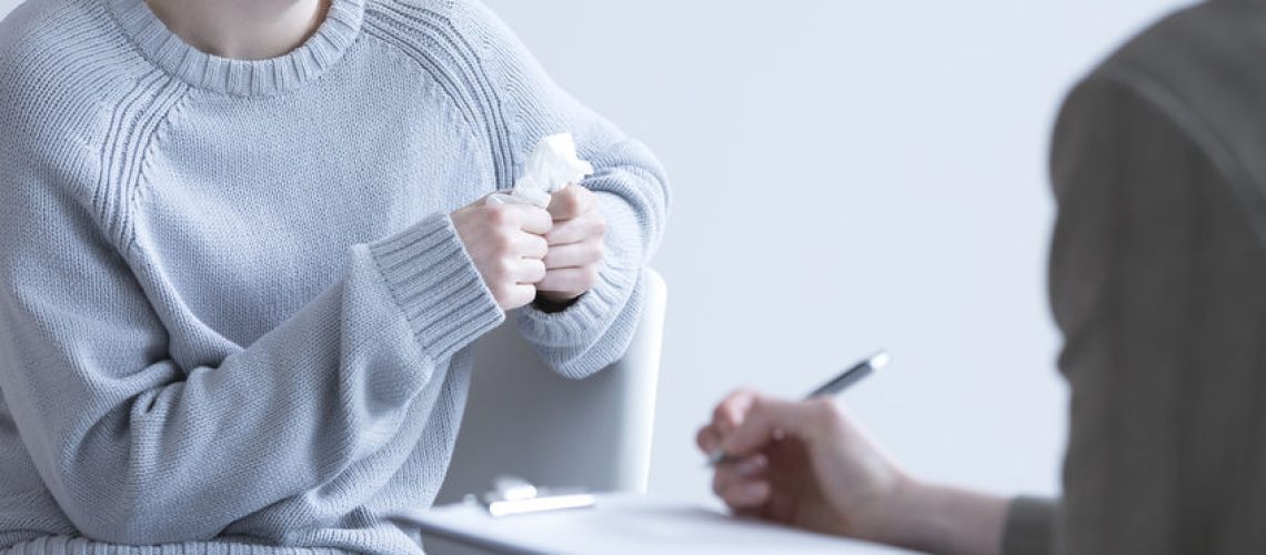 Crying woman suffering from depression and her psychologist