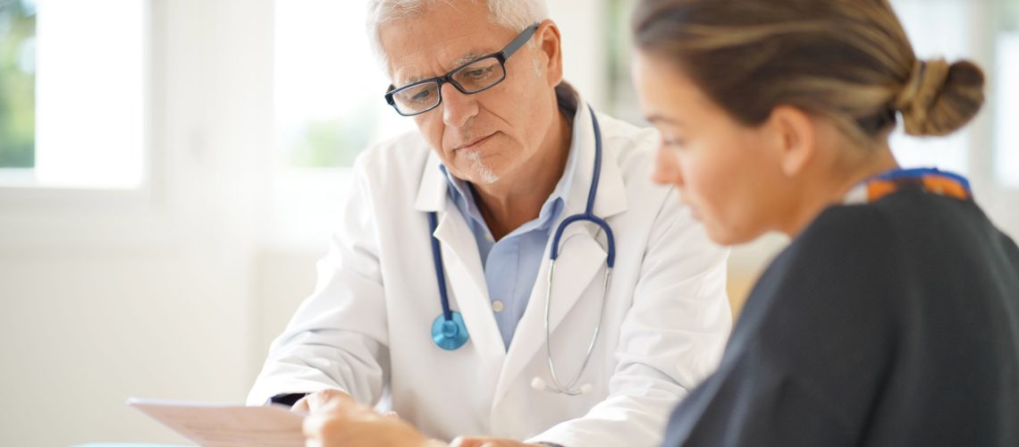 Doctor talking to patient in office