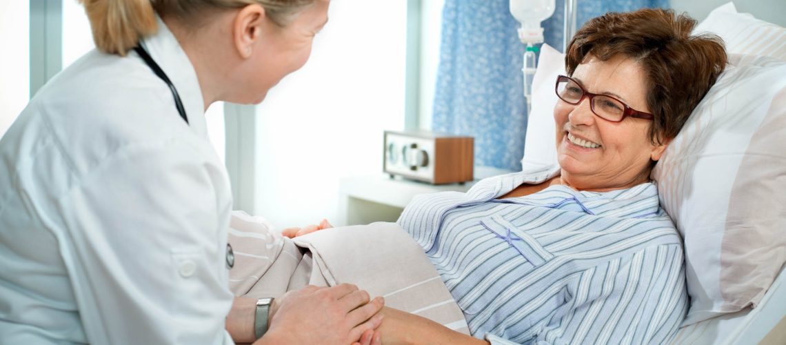 doctor or nurse talking to patient in hospital